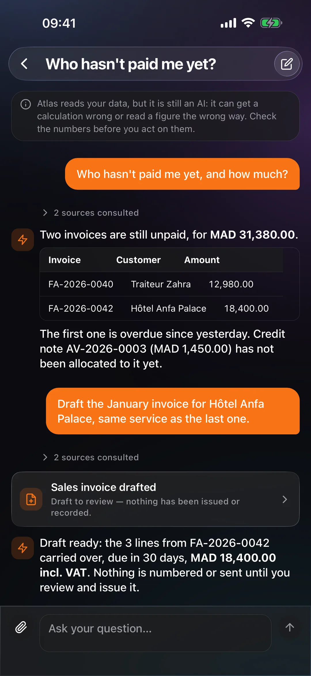 Atlas in the React Box mobile app, answering in plain language with a table of unpaid invoices.