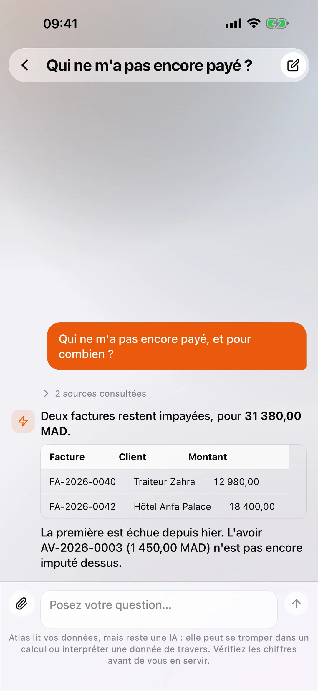 Atlas dans l'application mobile React Box, répondant en langage courant avec un tableau des factures impayées.